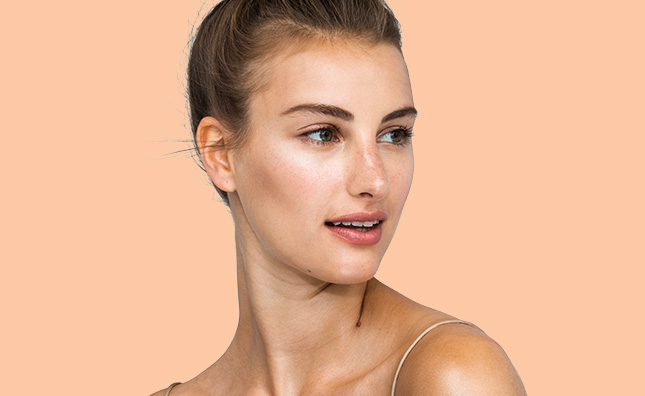 closeup of woman with radiant skin care and neutral makeup 